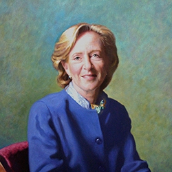 commissioned portrait of a woman sitting down in a blue pants suit, fingers intertwined. 