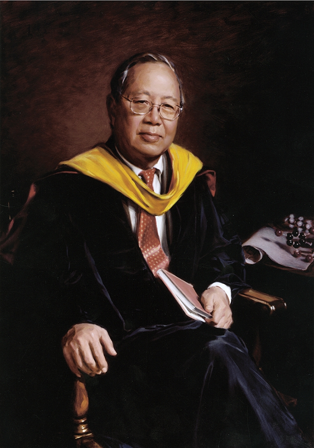commissioned portrait of man in black and yellow academic regalia sitting down