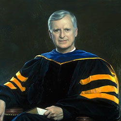 commissioned portrait of man sitting down, book in hand, wearing academic robes.