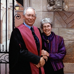 commissioned portrait of a man in regal dress and woman standing together, arms locked and smiling. 